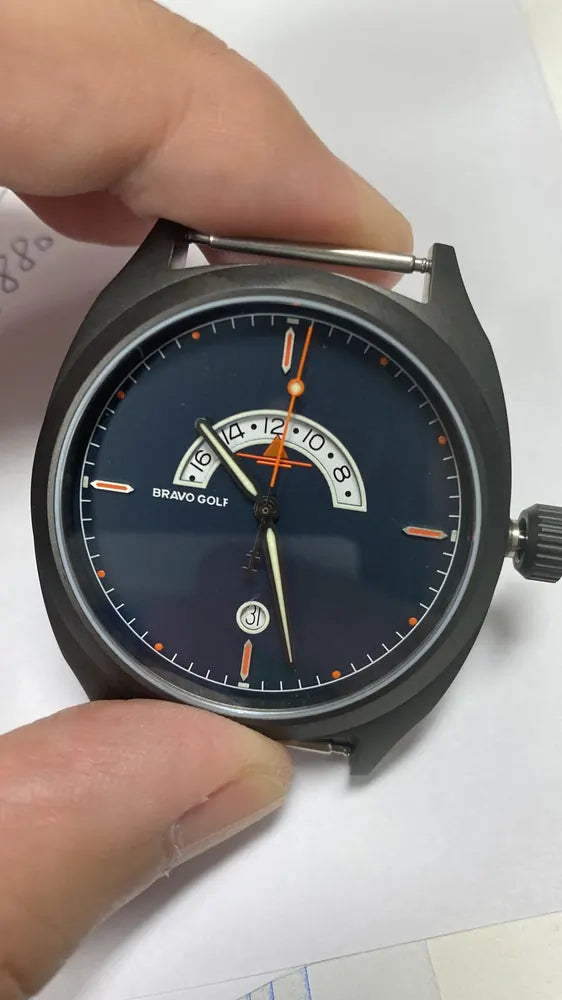 An early hand-held Bravo Golf watch prototype showing the crescent second-time-zone display