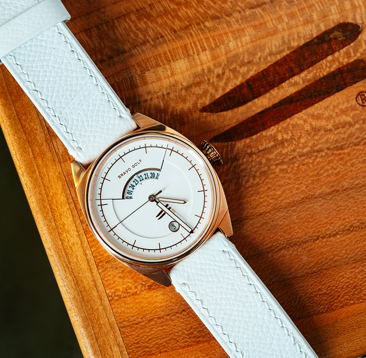 The Katharine watch with a pale dial, rose-tone case, and white Horween leather strap.