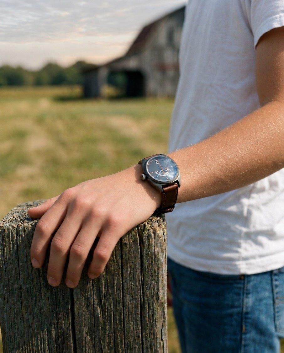 His forearm resting on his knee on the porch step, the Discovery 38 sitting flat on a slim wrist.