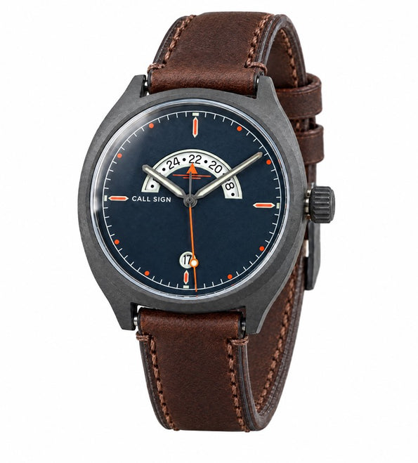 Call Sign Discovery 38 Classic: dark blue dial, orange accents, crescent GMT window at 12, gunmetal case, brown leather strap.