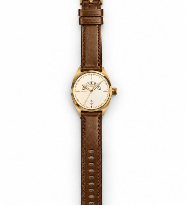The Discovery 38 Gold laid out full length on its brown leather strap.