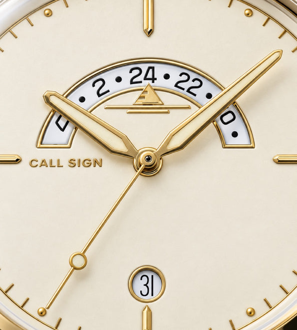 Close-up of the Gold dial: crescent GMT window, gold-tone hands and markers, date at six.
