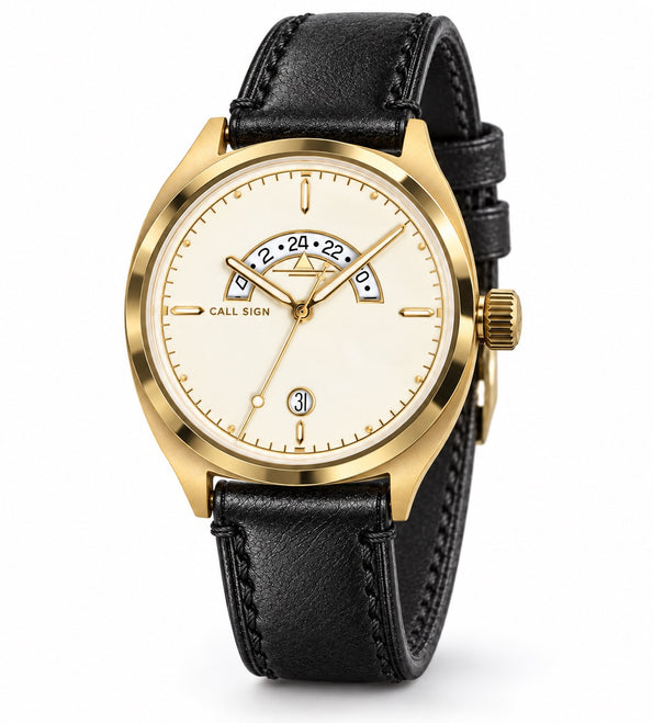 Call Sign Discovery 38 Gold: cream dial with gold accents, crescent GMT window at 12, gold-tone case, black leather strap.