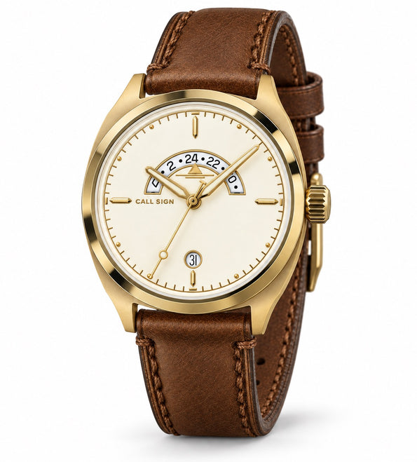 Call Sign Discovery 38 Gold: cream dial with gold accents, crescent GMT window at 12, gold-tone case, brown leather strap.