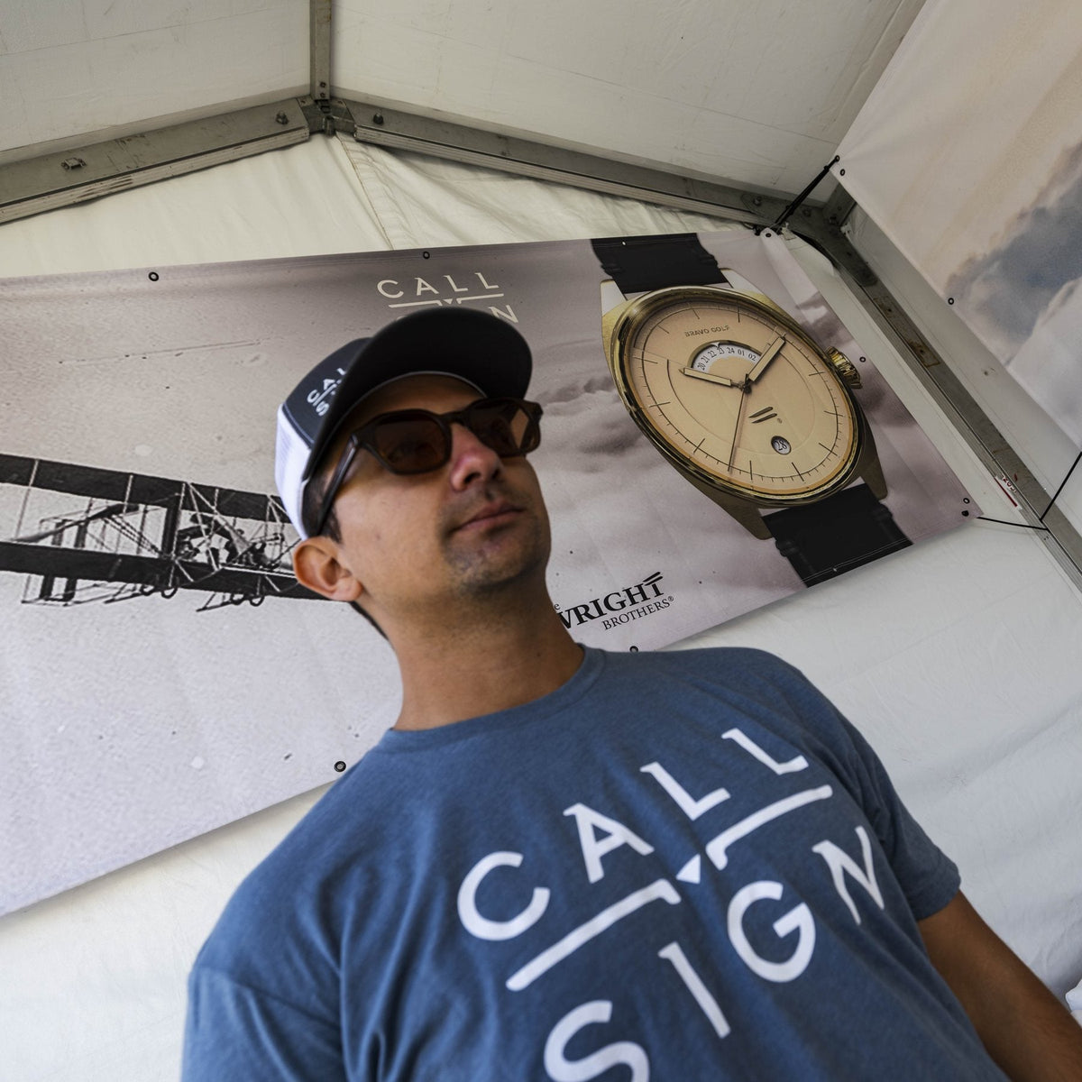 Beau Garrett in a Call Sign shirt at the booth in front of a Discovery banner.