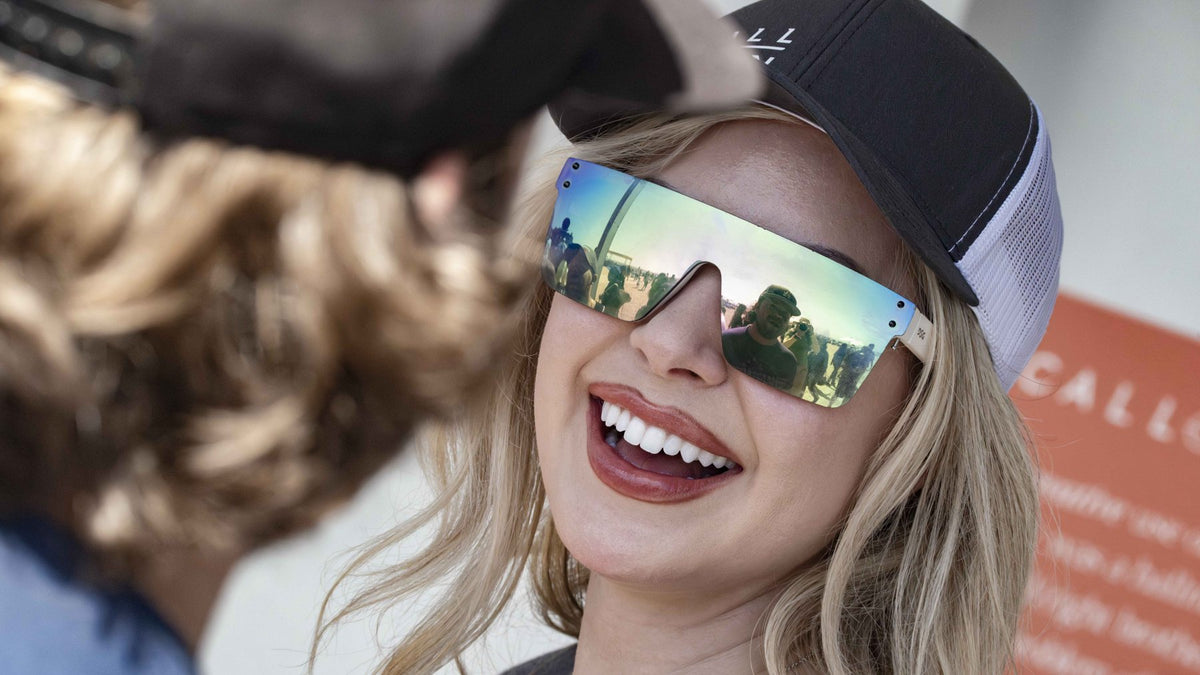 A customer laughing in mirrored sunglasses and a Call Sign cap.