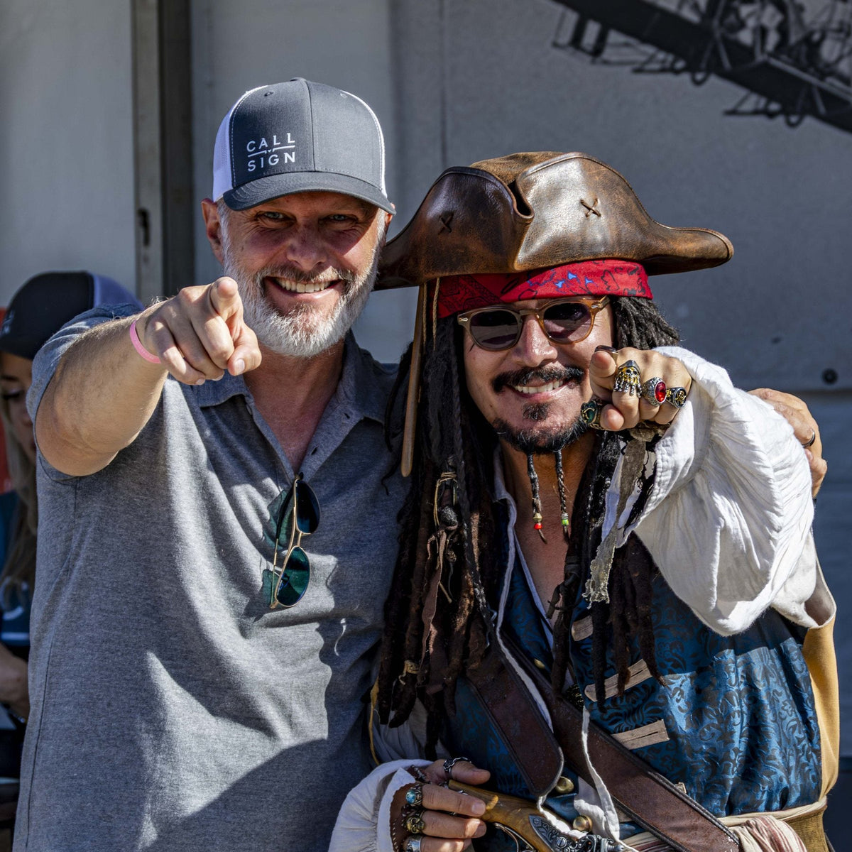 Beau Garrett pointing at the camera next to a man dressed as a pirate.